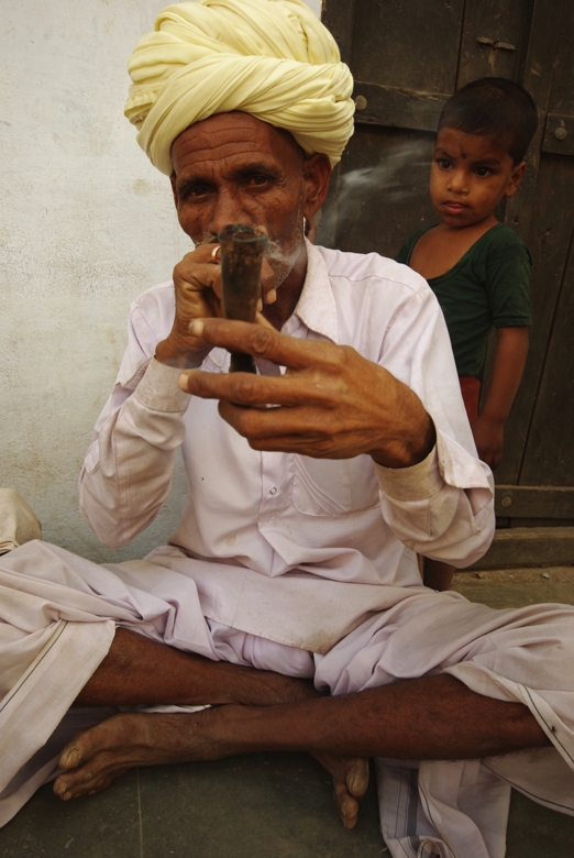 Indian local guy smoking authentic cigarette