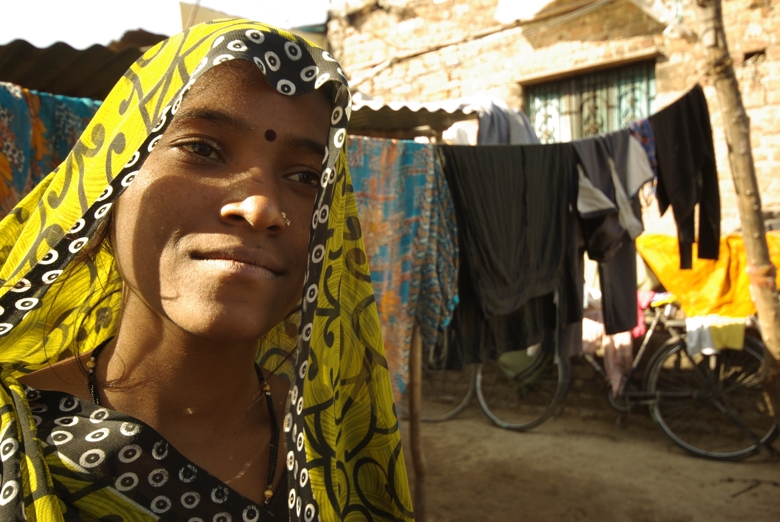 Indian woman in front of laundry