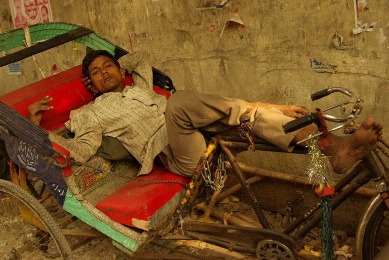 Indian guy lying on cargo bike