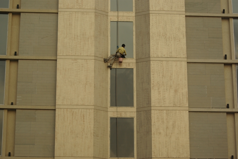 man cleaning window